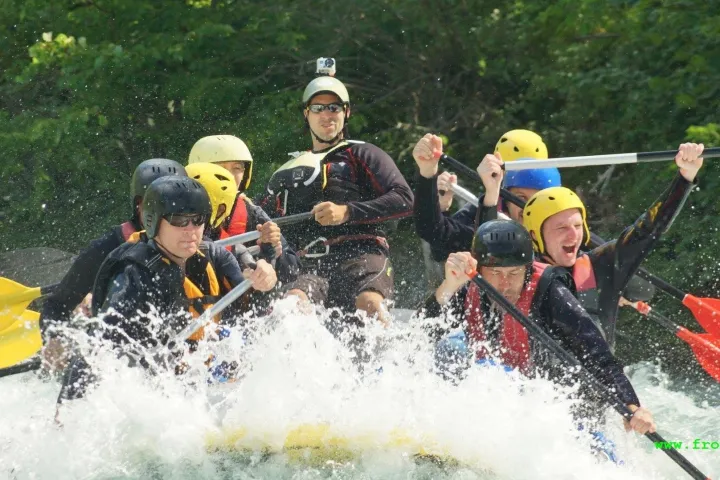 a group of people riding skis on a raft
