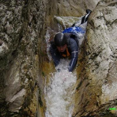 a man doing a trick on a rock in the snow