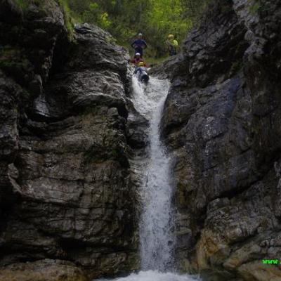 a large waterfall over a rocky cliff
