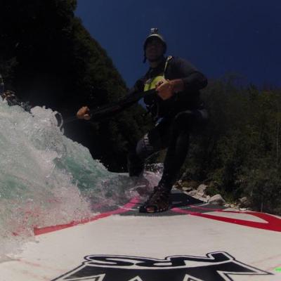a man riding a snowboard down a snow covered slope