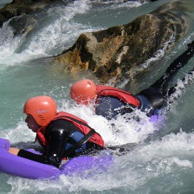 a young girl riding a wave on a surfboard in the water