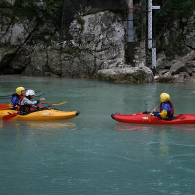a group of people riding on the back of a boat in the water