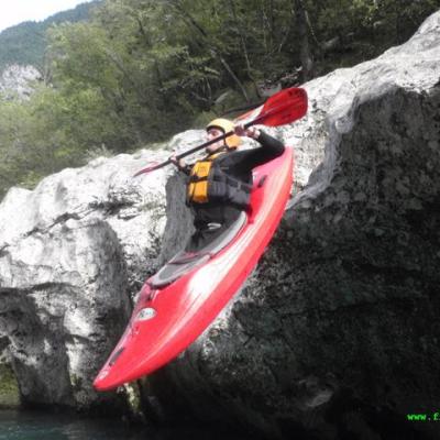 a person riding a motorcycle on the side of a mountain
