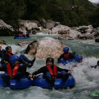 a group of people on a raft in a body of water
