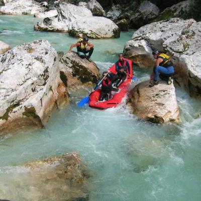 a group of people on a rock near the ocean